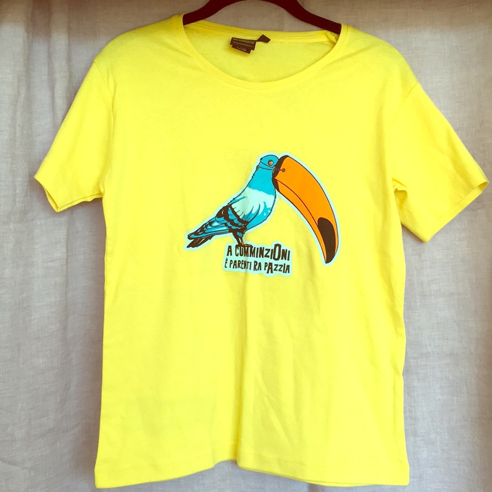 Bright yellow T-shirt with pidgin/parrot decal.